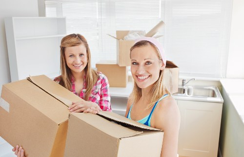 Packed boxes and furniture ready for loading by a local removals crew