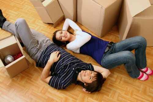 Movers carrying packed boxes during a same day relocation in Lissongrove