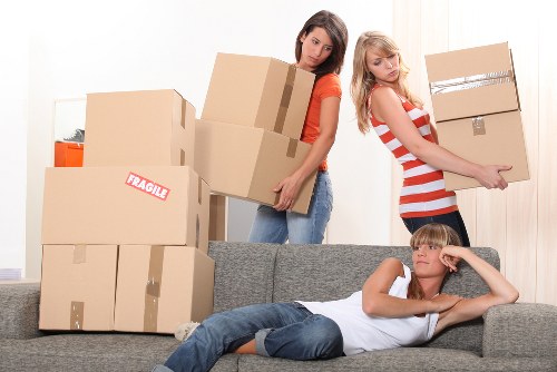 Local movers loading household items into a removal van